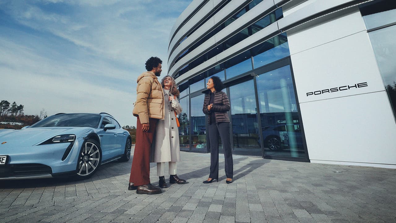 Group standing outside of a Porsche Center